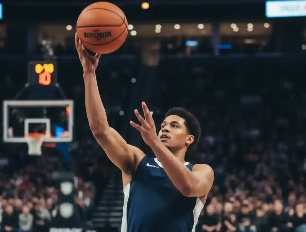 Jugador de baloncesto realizando un tiro en suspensión durante partido NBA